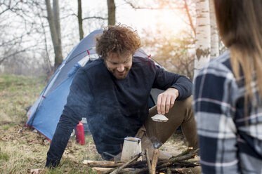 Couple camping in forest - ZOCF00507