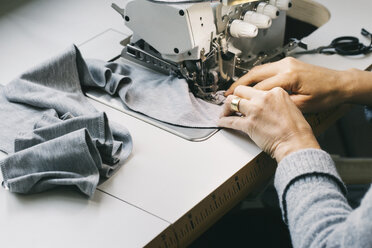 Close-up of woman using sewing machine - JUBF00281