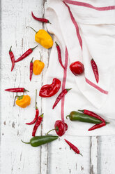 Various chili pods on kitchen towel and wood - LVF06308