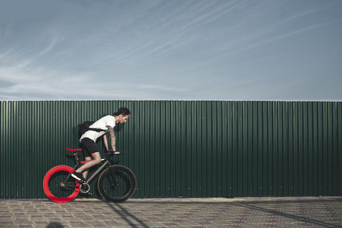 Young man riding fixie bike stock photo