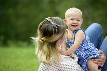 Mother playing with her baby girl in a park - LBF01661