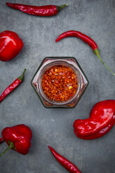 Various red chili pods and glass of chili flakes - LVF06315