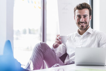 Portrait of smiling businessman in office - UUF11859