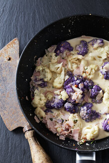 Pan of cauliflower florets with cooked ham and spices in cream sauce - CSF28301