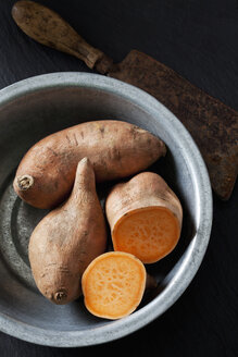 Sliced and whole sweet potato in metal bowl - CSF28312