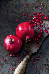 Two whole pomegranates, pomegranate seed and cleaver - CSF28335