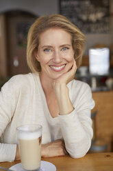 Portrait of relaxed woman with Latte Macchiato in a coffee shop - PNEF00027