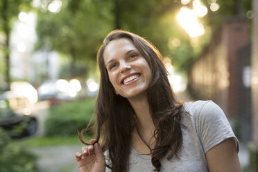 Portrait of happy young woman outdoors - PNEF00056