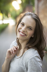 Portrait of smiling young woman outdoors - PNEF00057