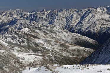 Austria, Tyrol, Oetztal, Soelden, woman in snowcapped landscape with view on Oetztal Glacier Road - GFF01041