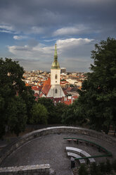 Slovakia, Bratislava, cityscape with St. Martin's Cathedral at sunset, hill park terrace with benches - ABOF00279