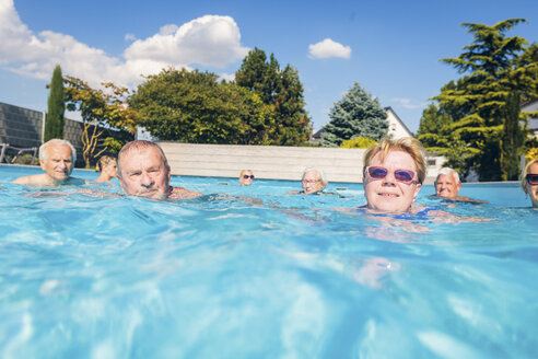 Group of seniors swimimng in swimming pool - PNPF00110