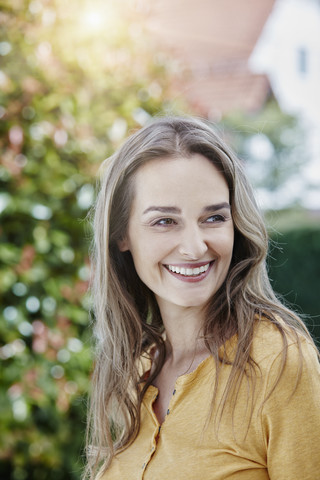 Portrait of happy woman in garden stock photo