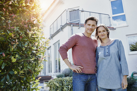 Portrait of couple in front of their home stock photo