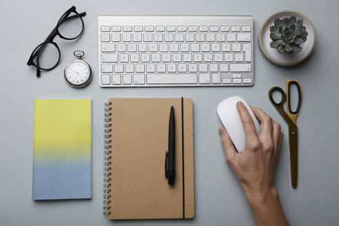 Top view of woman using computer mouse on desk - RBF06088