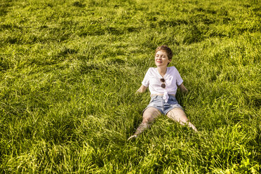 Woman in field enjoying sunlight - FMKF04556