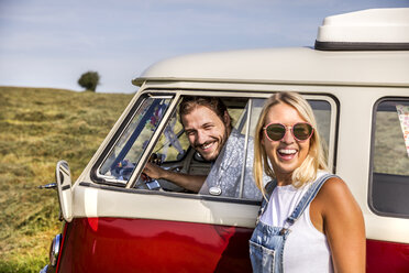 Happy couple with van in rural landscape - FMKF04557