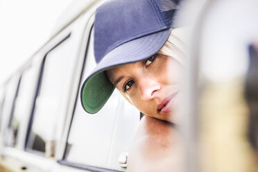 Young woman looking out of window of a van - FMKF04563