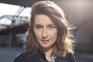 Portrait of woman with brown hair at backlight - PNEF00166