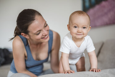 Portrait of baby girl with mother on couch - DIGF02888