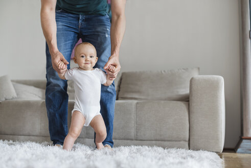 Vater mit kleinem Mädchen zu Hause im Wohnzimmer - DIGF02894