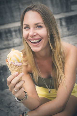 Portrait of happy young woman holding ice cream cone stock photo