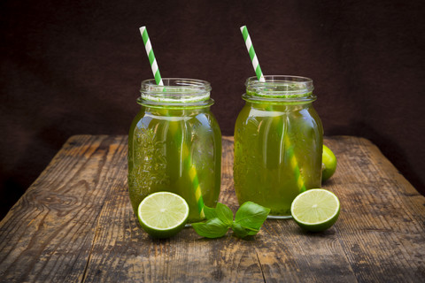 Two glasses of organic lime lemonade with basil stock photo