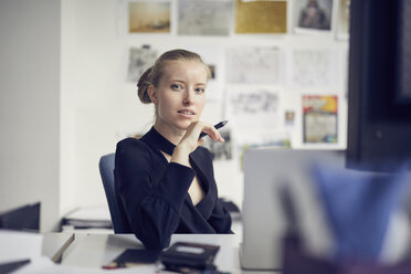 Portrait of young businesswoman at desk in the office - PNEF00177