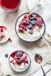 Bowl of natural yoghurt with raspberry sauce and frozen fruits - SBDF03324