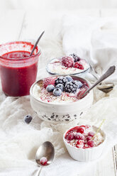 Bowl of natural yoghurt with raspberry sauce and frozen fruits - SBDF03329