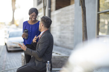 Colleagues talking outside office building - ZEF14641