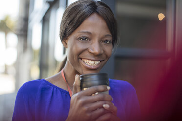 Portrait of smiling businesswoman with coffee mug - ZEF14643