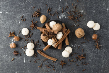 Spices, nuts and aniseed biscuit on grey ground - MYF01964