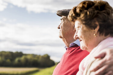 Senior couple embracing in rural landscape - UUF12035