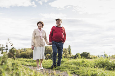 Senior couple on a walk in rural landscape - UUF12037