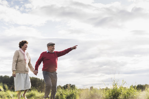 Älteres Paar bei einem Spaziergang in ländlicher Landschaft, lizenzfreies Stockfoto