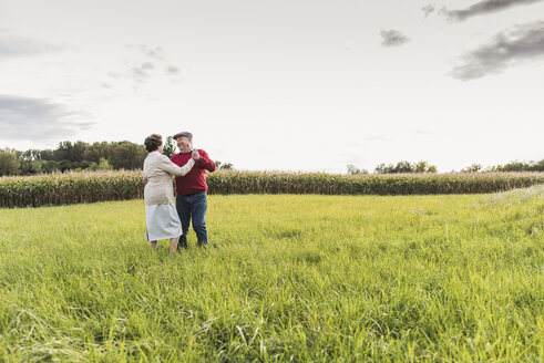 Senior couple dancing in rural landscape - UUF12058