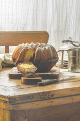 Marble cake on wooden board and old kitchen table - ODF01557