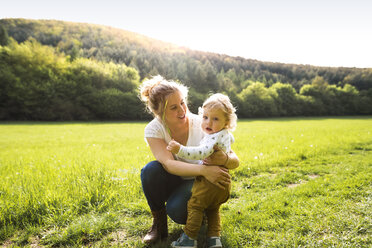 Cute little boy with mother on meadow - HAPF02294