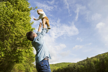 Father throwing baby in the air - HAPF02298