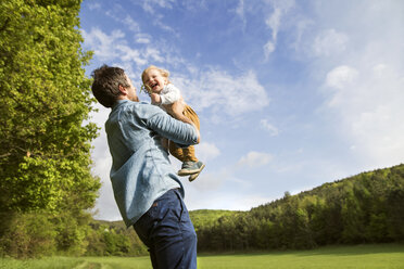 Father holding happy baby in the nature - HAPF02299