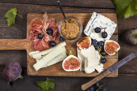 Cheese platter with fruits and fig mustard stock photo