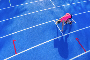 Top view of female runner in starting position - STSF01330