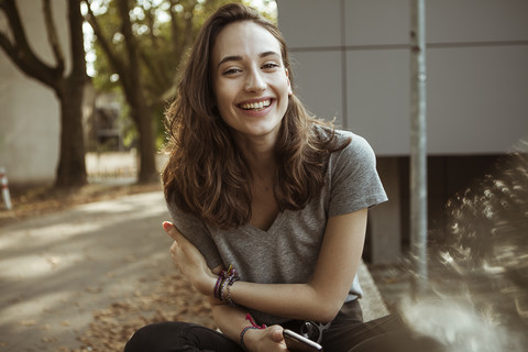 Portrait of happy young woman outdoors stock photo