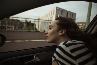 Young woman leaning out of car window - FEXF00312