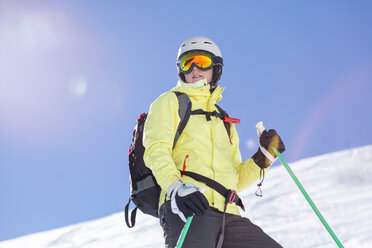 Austria, Bludenz, woman with ski helmet and avalanche backpack in the mountains - MMAF00166