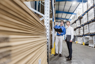 Two businessmen having a meeting in company warehouse - DIGF02998