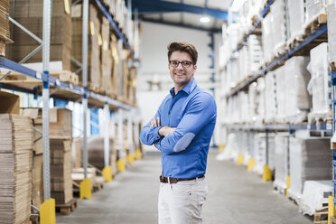 Businessman standing in warehouse, portrait - DIGF02999