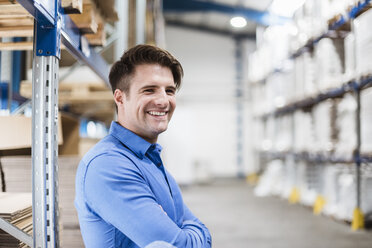 Businessman standing in warehouse, portrait - DIGF03000