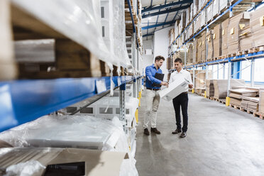 Two businessmen having a meeting in company warehouse - DIGF03012